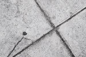 old floor made of concrete blocks, pattern and texture, grunge background, weathered textured surface photo