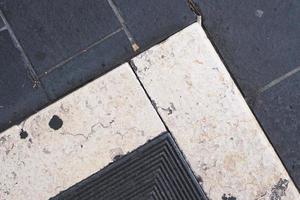 close up of a block pavement with metal lattice, pattern and texture, weathered textured surface, grunge background photo