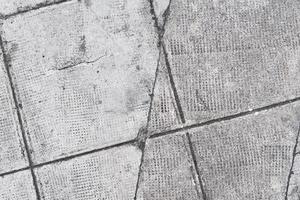 close up of a cement floor blocks, pattern and texture, grunge background, weathered textured surface photo
