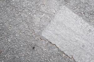 Grey concrete facade wall with stains, pattern and texture, weathered textured surface photo