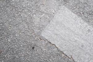 Grey concrete facade wall with stains, pattern and texture, weathered textured surface photo