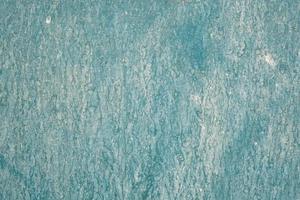 Painted in turquoise color wet wooden wall, dirty board surface, texture and pattern, grunge background, weathered building facade. photo