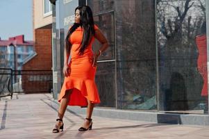 African american woman model xxl in orange dress. photo