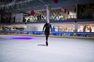 Figure skater woman at ice skating rink. photo