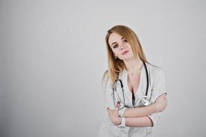 Blonde sexy doctor nurse with stethoscope isolated on white background. photo