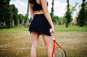 Beautiful sport woman tennis player with racket in sportswear costume. photo