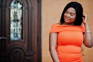 African american woman model xxl in orange dress. photo