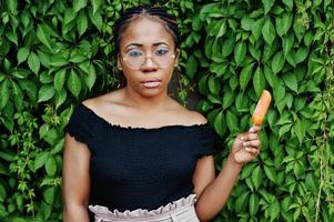 Stylish african american woman at glasses with ice cream. photo