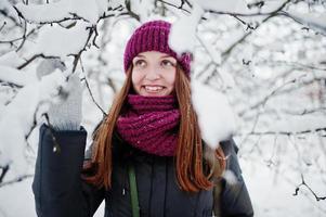 Portrait of girl at winter snowy day near snow covered trees. photo