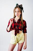 Young funny housewife in checkered shirt and yellow shorts pin up style isolated on white background. photo