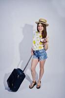 Girl tourist with bag, wear in shirt, shorts and hat with glasses isolated on white. photo