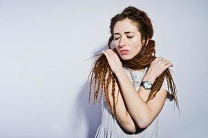 sesión de estudio de chica en vestido gris con rastas coletas sobre fondo blanco. foto