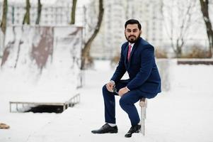 Stylish indian beard business man in suit posed at winter day outdoor. photo