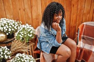 Stylish trendy afro france curly woman posed at autumn day in jeans jacket. Black african female model. photo