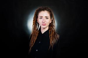 Studio shoot of girl in black with dreads at black background with nimbus. photo