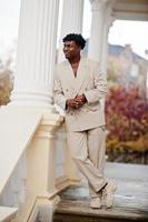 Stylish afro man in beige old school suit. Fashionable young African male in casual jacket on bare torso. photo