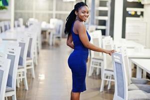 Charming african american woman posing at restaurant. photo