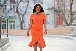 African american woman model xxl in orange dress. photo