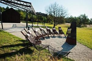 Fireplace with wooden chairs. Place for relax outdoor. photo