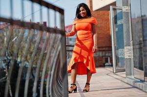 African american woman model xxl in orange dress. photo