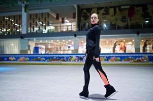 Figure skater woman at ice skating rink. photo