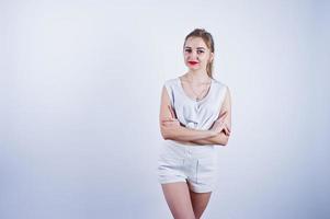 Amazing fit sexy body brunette caucasian girl posing at studio against white background on shorts and top. photo