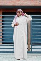 Middle Eastern arab man posed on street against modern building. photo