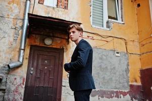 Young stylish macho boy in black jacket posed outdoor of street. Amazing model man. photo