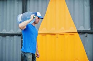 Delivery man carrying water bottle on shoulder. photo