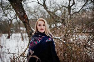 Blonde girl with hand embroidered scarf posed at winter day. Women's handkerchief. photo