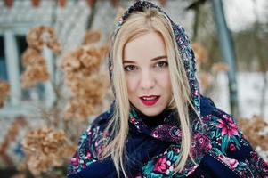 Blonde girl with hand embroidered scarf posed at winter day. Women's handkerchief. photo