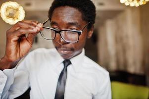Close up of business african american man wear on white shirt, tie and glasses at office. photo