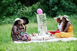 Group of african american girls celebrating birthday party outdoor with decor. photo