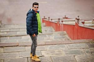 Indian man at  jacket with sunglasses posed outdoor. photo