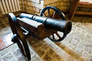 Very old cannon made of iron in museum. photo