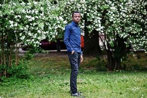 African  man posed at street of city wear on blue shirt and black pants. photo