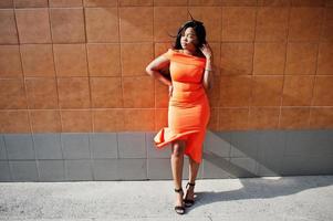 African american woman model xxl in orange dress. photo