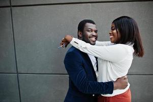 Stylish african american couple in formal wear hugs together. Romantic couple in love dating. photo