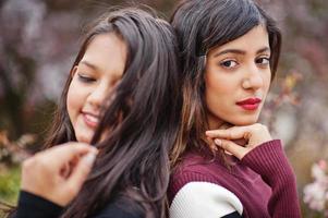 Portrait of two young beautiful indian or south asian teenage girls in dress. photo