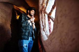 Beard asian man in casual wear stand inside house on stairs against window. photo