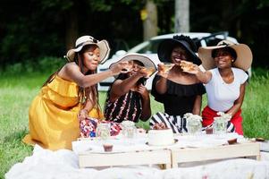 Group of african american girls celebrating birthday party and clinking glasses outdoor with decor. photo