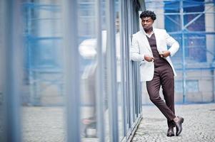 Thoughtful young handsome african american gentleman in formalwear. Black stylish model man in white jacket. photo