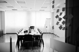 Modern business office interior containing tables and chairs, laptop, camera and office supplies with no employees. photo