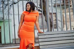 African american woman model xxl in orange dress. photo