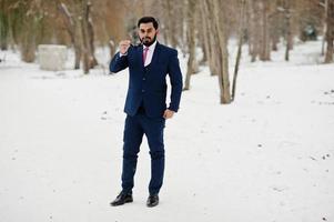 Stylish indian beard business man in suit and sunglasses posed at winter day outdoor. photo