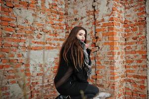 Brunette stylish casual girl in scarf against brick place. photo