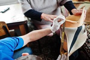 The prosthetist removes the measure from a person with a disability, woman with amputee. photo