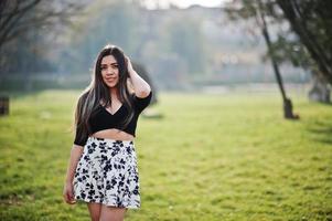 Pretty latino model girl from Ecuador wear on black tops and skirt posed at street. photo