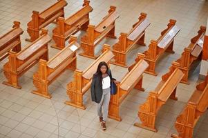 African american woman praying in the church. Believers meditates in the cathedral and spiritual time of prayer. View from above. photo