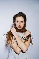 Studio shoot of girl in gray dress with dreads pigtails on white background. photo